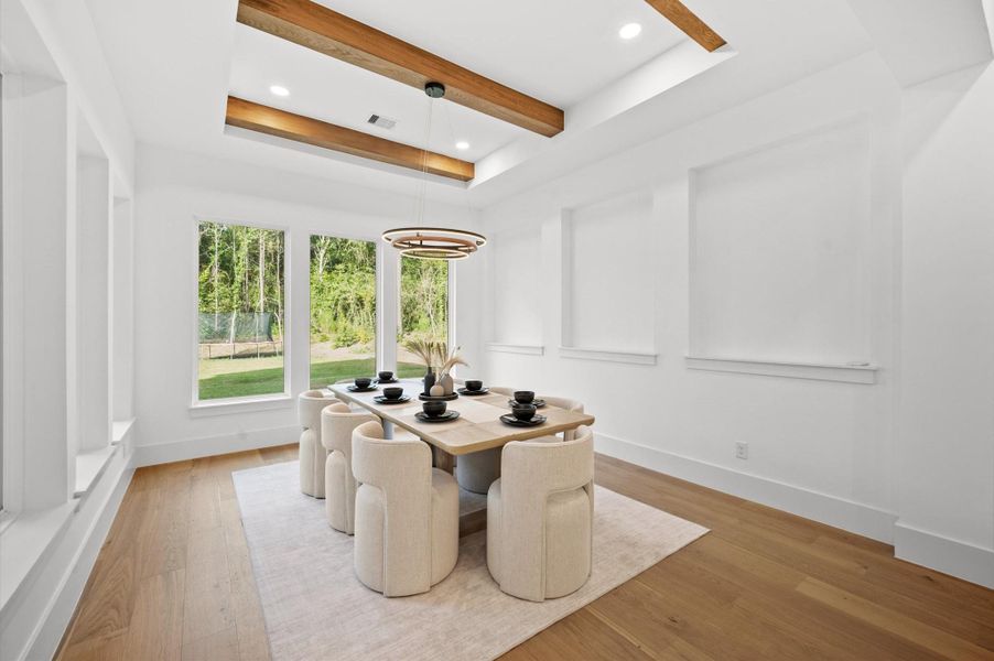 Bright dining space overlooking the backyard and wooded surroundings.
