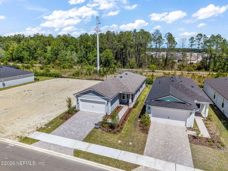 Front exterior of a new home in Del Webb Wildlight, Yulee, FL, highlighting curb appeal (Image 23).