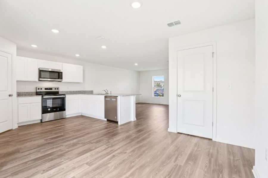 A kitchen with white cabinets.