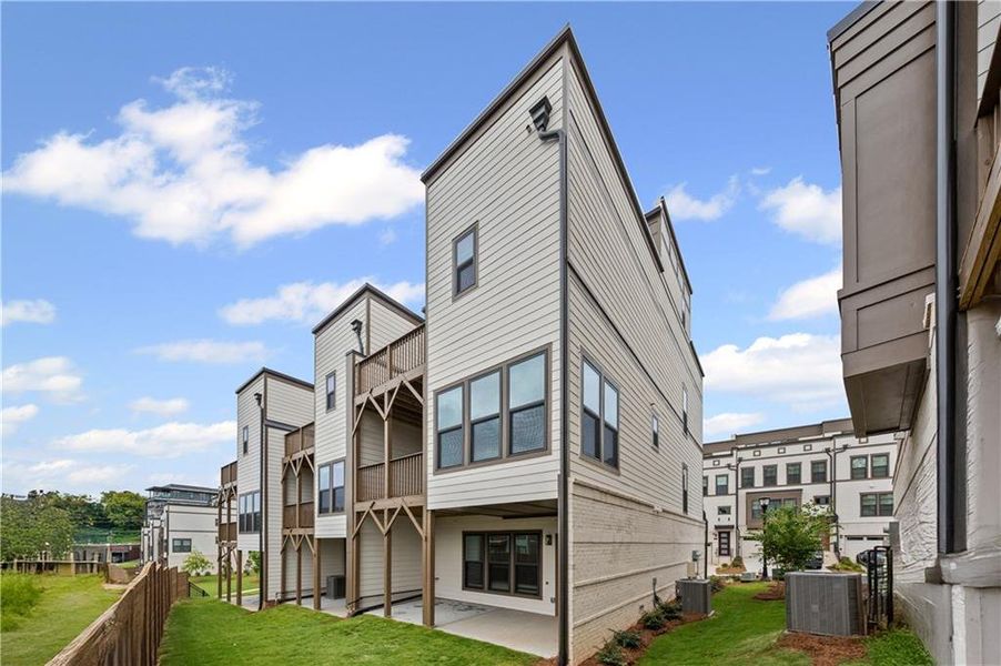Front exterior of a new home in Altus at The Quarter, Atlanta, GA, highlighting curb appeal (Image 1).