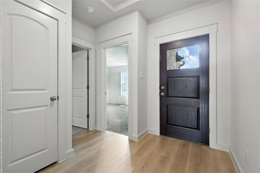 Foyer entrance with light wood-style floors and baseboards Foyer entrance with light wood-style floors and baseboards