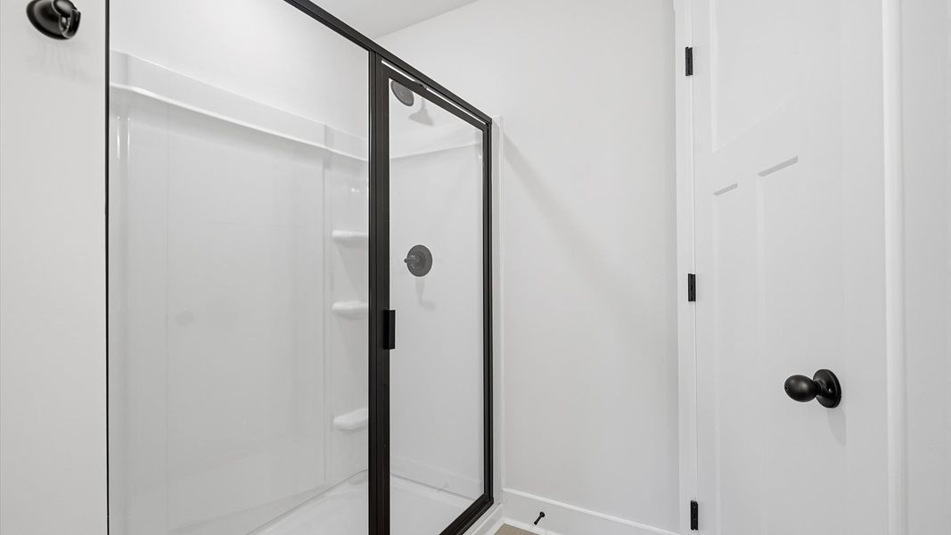 Highly functional and elegant en-suite with a tiled walk-in shower, and refined finishes by DRB Homes Highly functional and elegant en-suite with a tiled walk-in shower, and refined finishes by DRB Homes