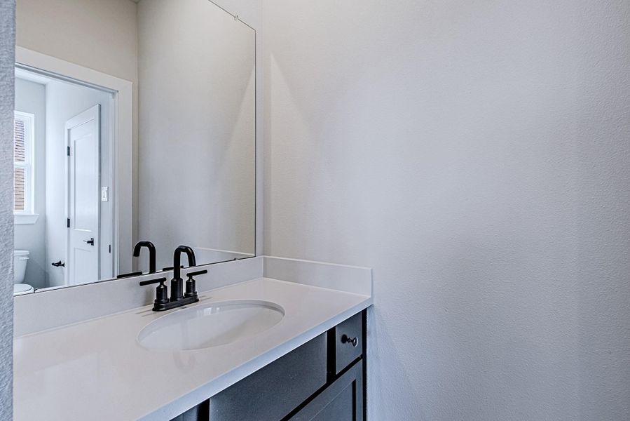 Modern bathroom vanity with ample counter space and dark cabinetry