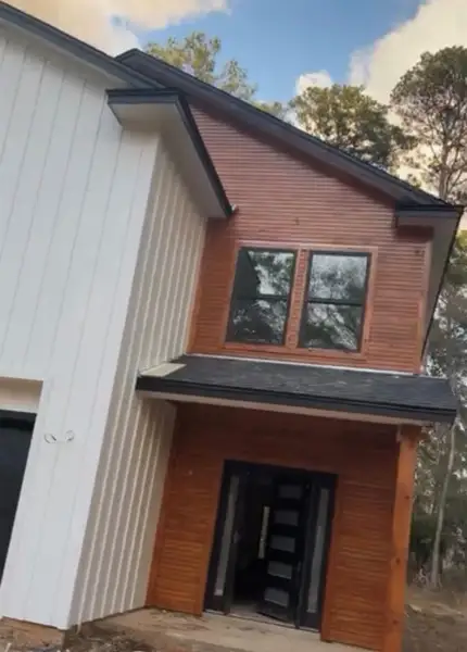 Front exterior of a new home in , Conroe, TX, highlighting curb appeal (Image 2).