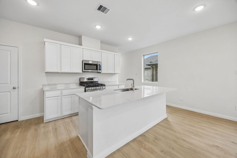 Kitchen in the Magnolia home plan by Trophy Signature Homes – REPRESENTATIVE PHOTO