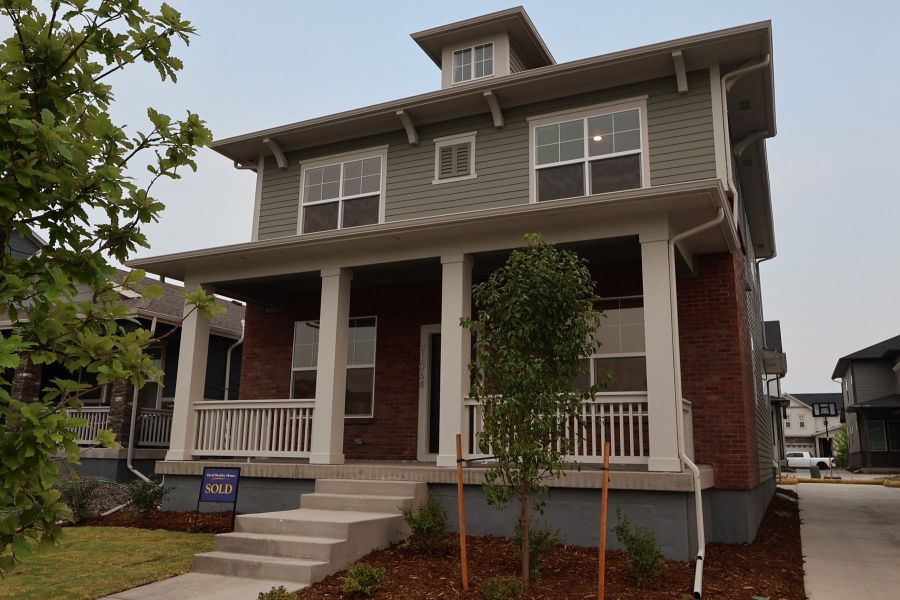 Front exterior of a new home in Painted Prairie Cottage Collection, Aurora, CO, highlighting curb appeal (Image 22).
