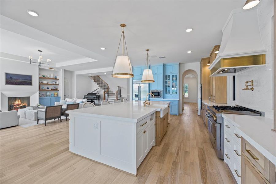 Lots of beautiful cabinets to hold all the gadgets and keep the counters and extra large island clean so you can show off the gorgeous quartz.