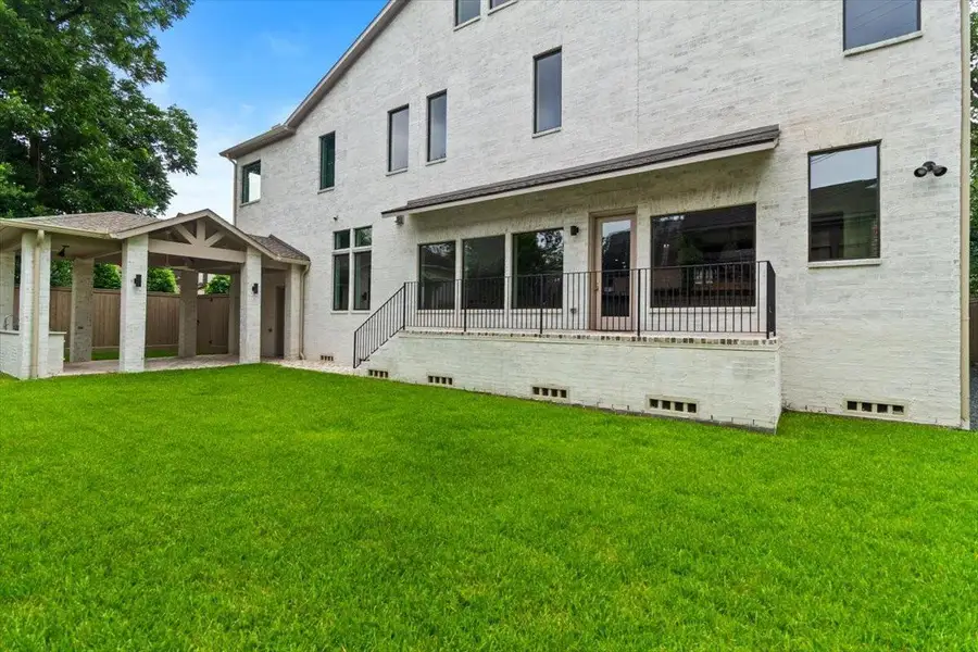 Large back yard has plenty of room for a pool the outdoor kitchen opens directly to this space