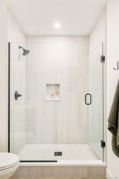 Walk-in shower with floor-to-ceiling tile