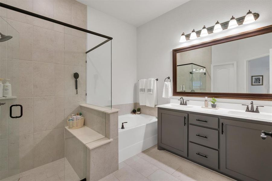 Bathroom with shower with separate bathtub, vanity, and tile patterned floors