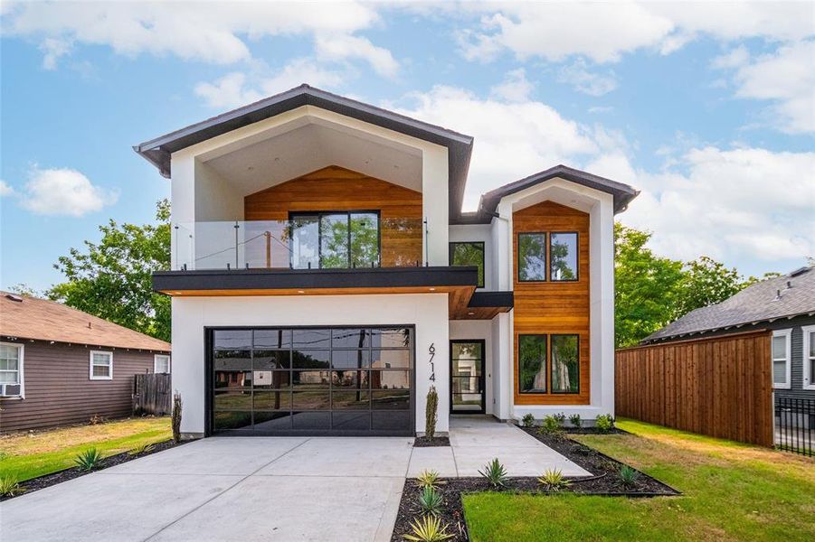 Contemporary home featuring a front lawn and a balcony