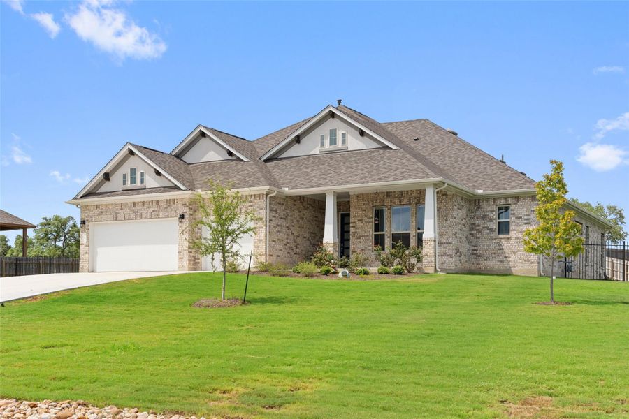 Craftsman-style house with roof with shingles, brick siding, concrete driveway, and a garage