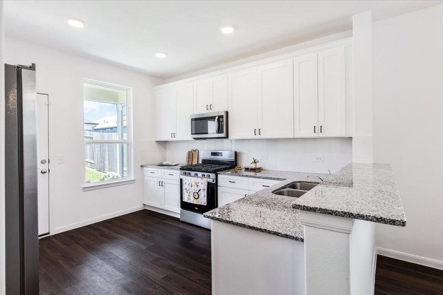 Kitchen features granite countertops , beautiful white cabinets with updates hardware, stainless appliances, large sink and natural light. Kitchen features granite countertops , beautiful white cabinets with updates hardware, stainless appliances, large sink and natural light.