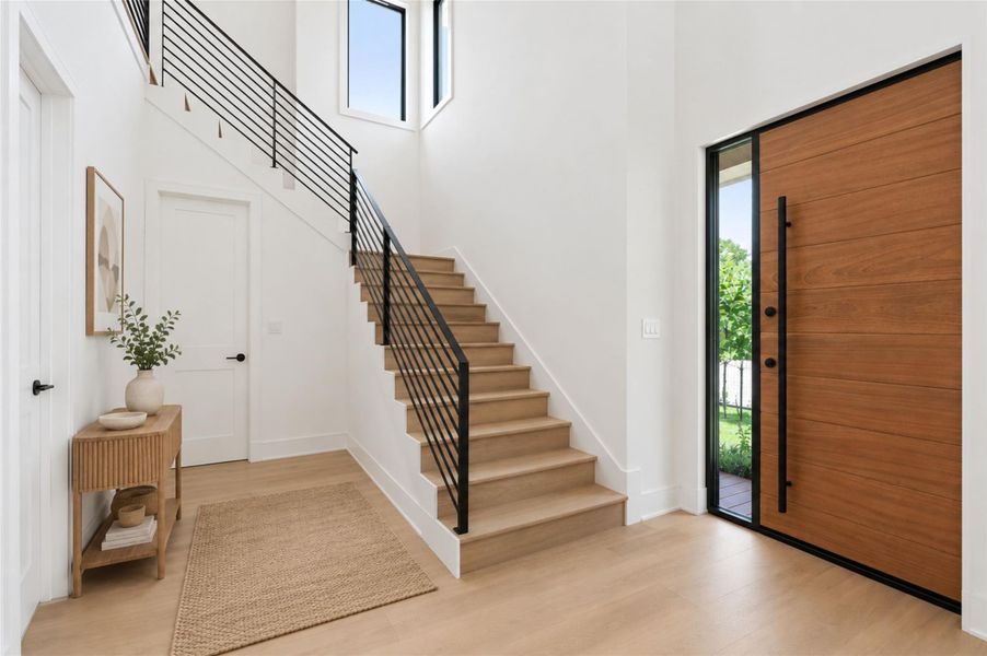 Grand entryway with gorgeous oak flooring and abundance of natural light. *Virtually staged.