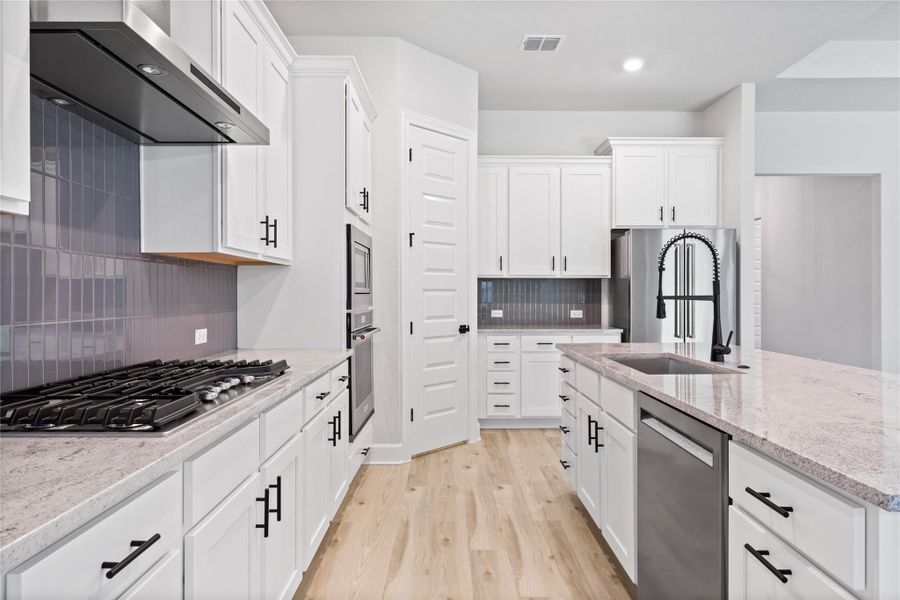 Beautiful, sleek cabinets with black iron hardware.