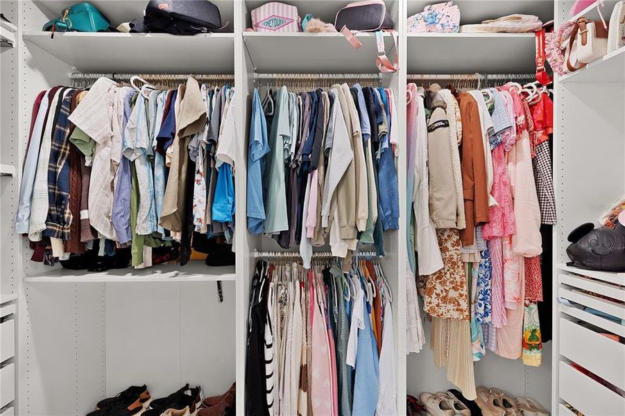 Primary walk-In closet with custom built ins