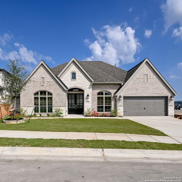 Front exterior of a new home in Johnson Ranch 70', Bulverde, TX, highlighting curb appeal (Image 22). Front exterior of a new home in Johnson Ranch 70', Bulverde, TX, highlighting curb appeal (Image 22).
