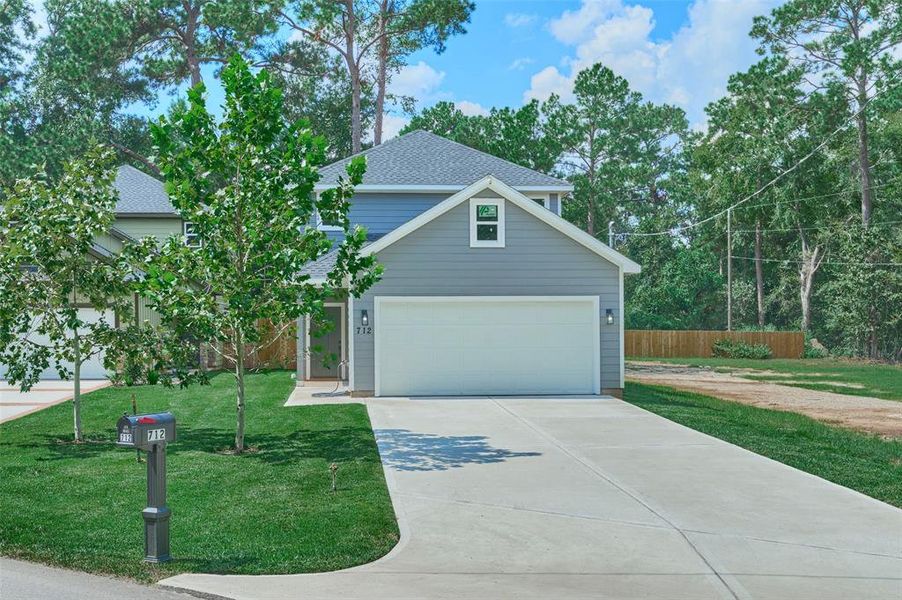 Grand two-story home with a spacious two-car garage features 4 bedooms {Primary bedroom is down},  and is nestled in the heart of Conroe close to everything yet offers privacy.