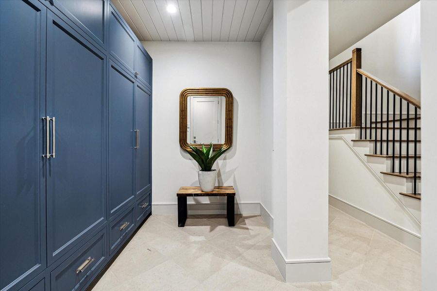Entering from the garage leads you through the mud room with 3 massive banks of wardrobe-style cabinets for your coats, shoes, sporting gear, and so much more.