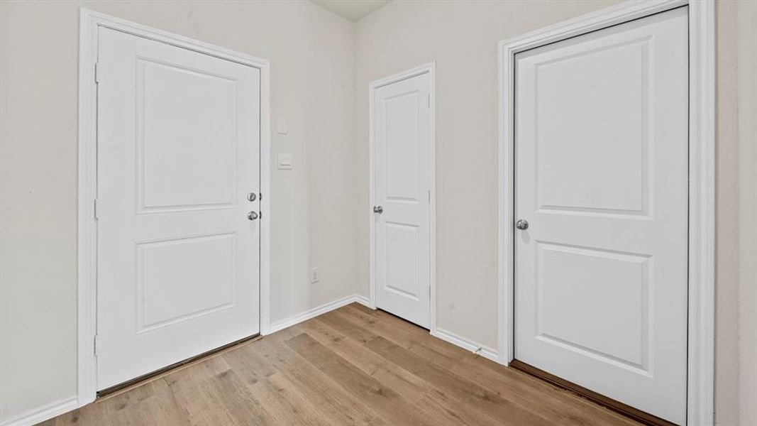 Entrance foyer featuring light wood finished floors and baseboards