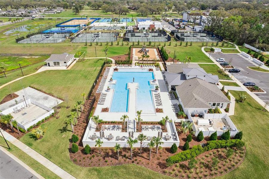 Aerial view of the community clubhouse, pool and tennis courts. Aerial view of the community clubhouse, pool and tennis courts.
