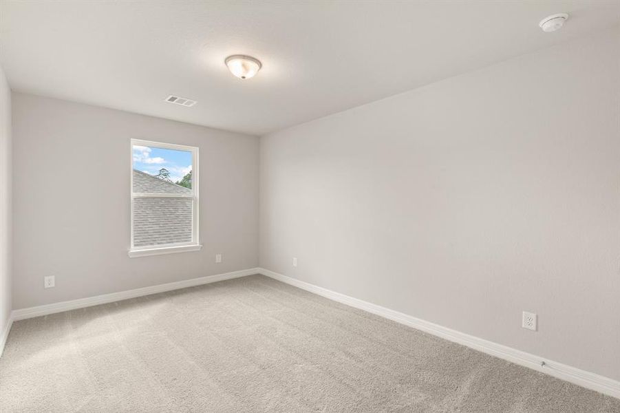 Your secondary bedroom features plush carpet, fresh paint, closet, and a large window that lets in plenty of natural lighting.