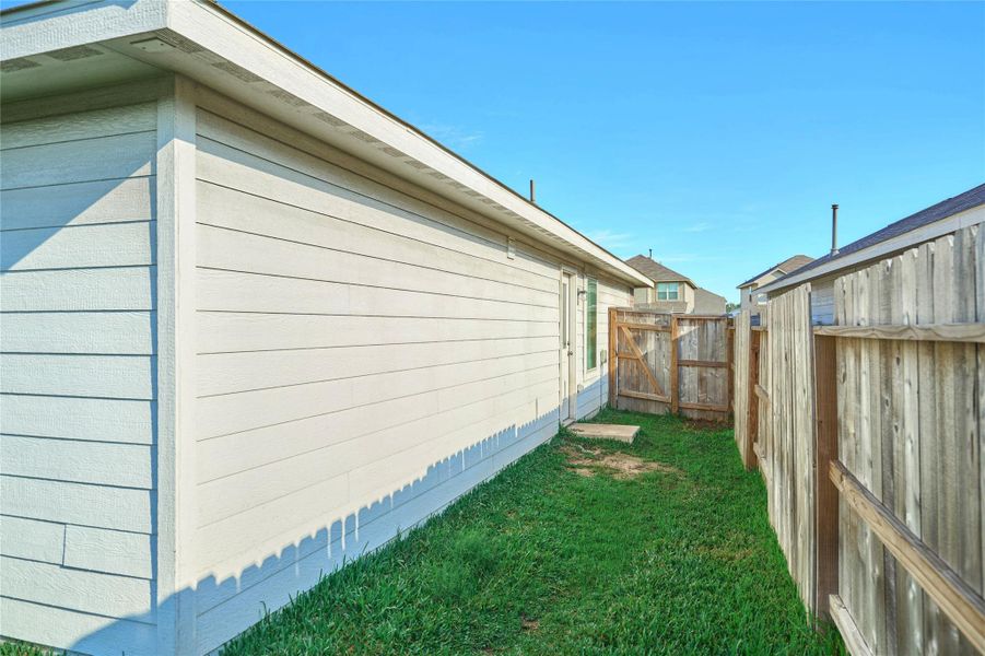 Exterior details and patio area of a home in Tavola: Cottage Collection, New Caney (Image 21).