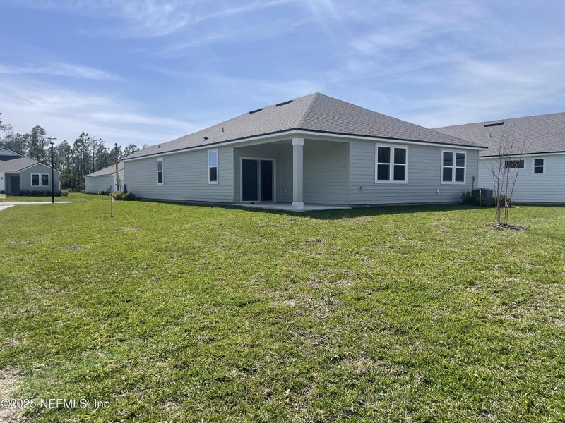 Exterior details and patio area of a home in Magnolia Series at Seminole Palms, Palm Coast (Image 2).
