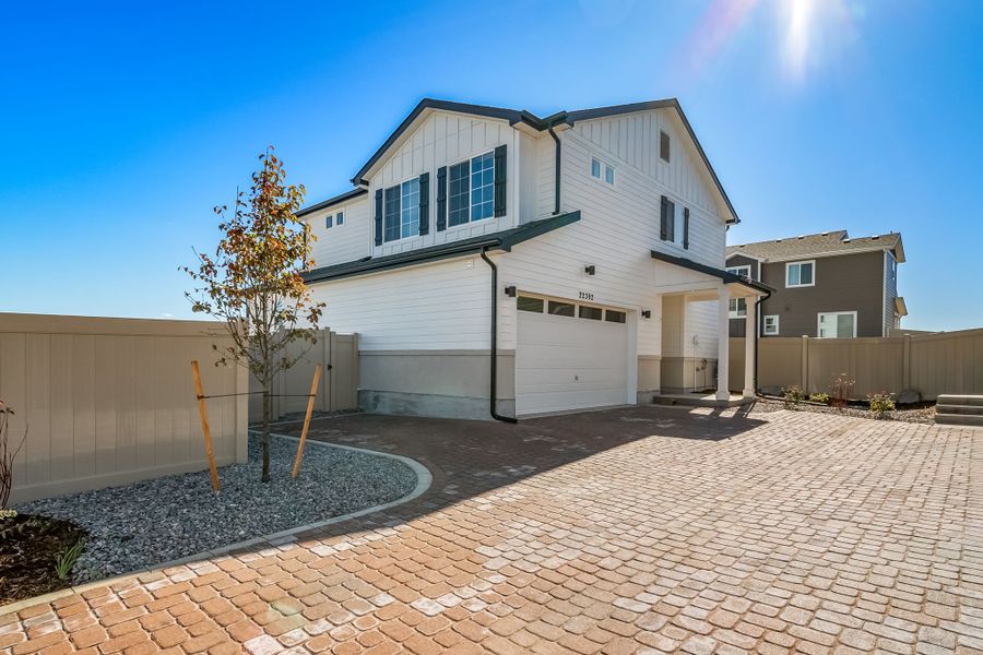 Front exterior of a new home in Green Valley Ranch, Aurora, CO, highlighting curb appeal (Image 1). Front exterior of a new home in Green Valley Ranch, Aurora, CO, highlighting curb appeal (Image 1).