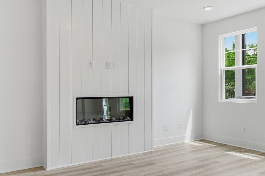 A room with a tv and a window.
