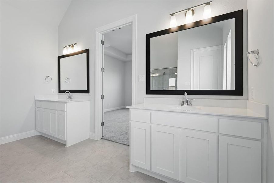 Full bath with two vanities and vaulted ceiling