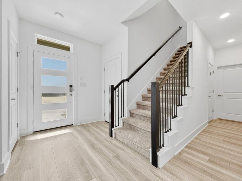Entryway featuring light wood-style floors and recessed lighting