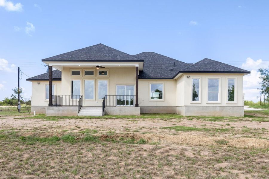 View of front of home with roof with shingles, stucco siding, and a porch View of front of home with roof with shingles, stucco siding, and a porch
