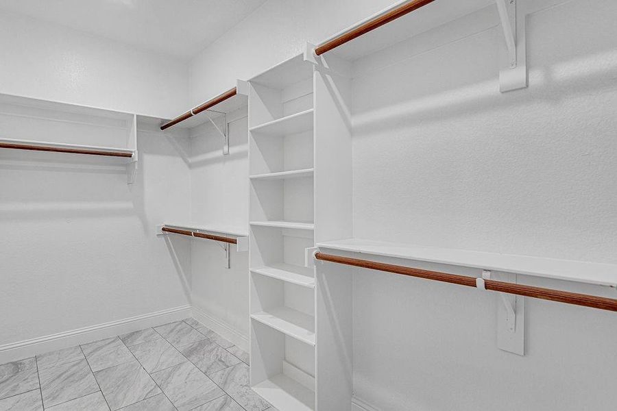 Walk in closet featuring light tile patterned flooring