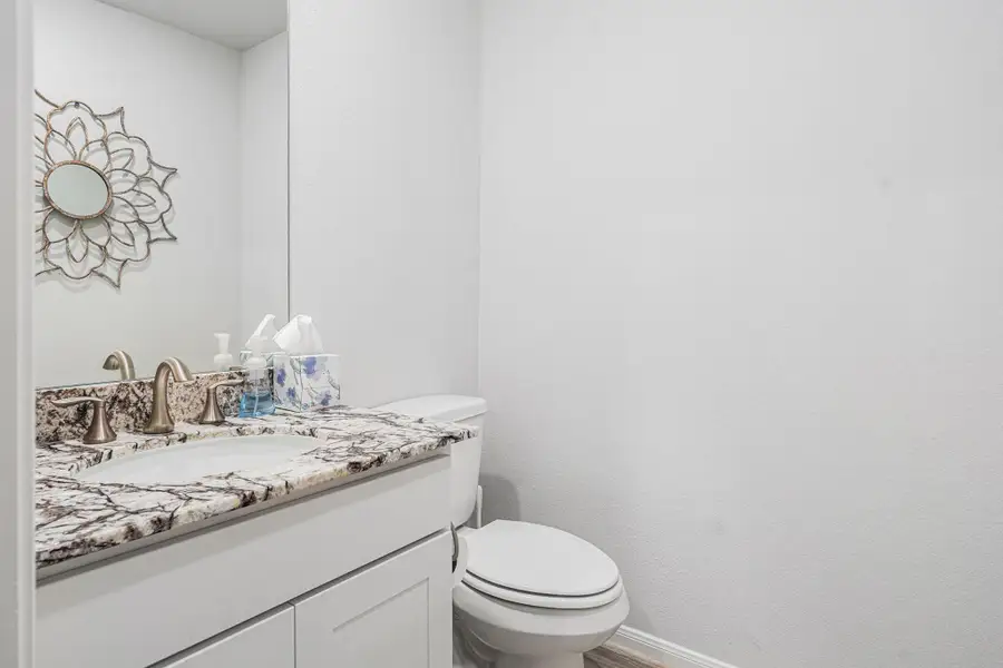 The half bath is in the entrance hallway. The half bath is in the entrance hallway.