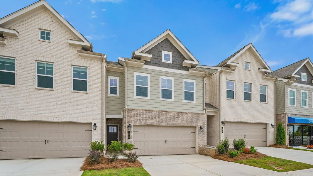 Front exterior of a new home in Abbotts Crossing Towns, Conyers, GA, highlighting curb appeal (Image 1). Front exterior of a new home in Abbotts Crossing Towns, Conyers, GA, highlighting curb appeal (Image 1).