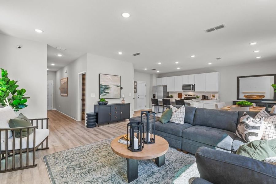 A living room with a couch and a table. A living room with a couch and a table.