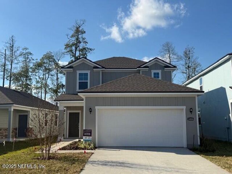 Front exterior of a new home in , Jacksonville, FL, highlighting curb appeal (Image 1).
