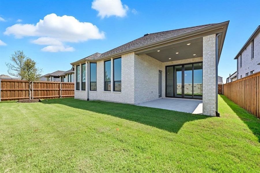 Back of property featuring brick siding, a patio, a fenced backyard, and roof with shingles Back of property featuring brick siding, a patio, a fenced backyard, and roof with shingles