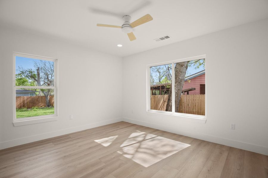 Empty room featuring light wood-type flooring, recessed lighting, and ceiling fan