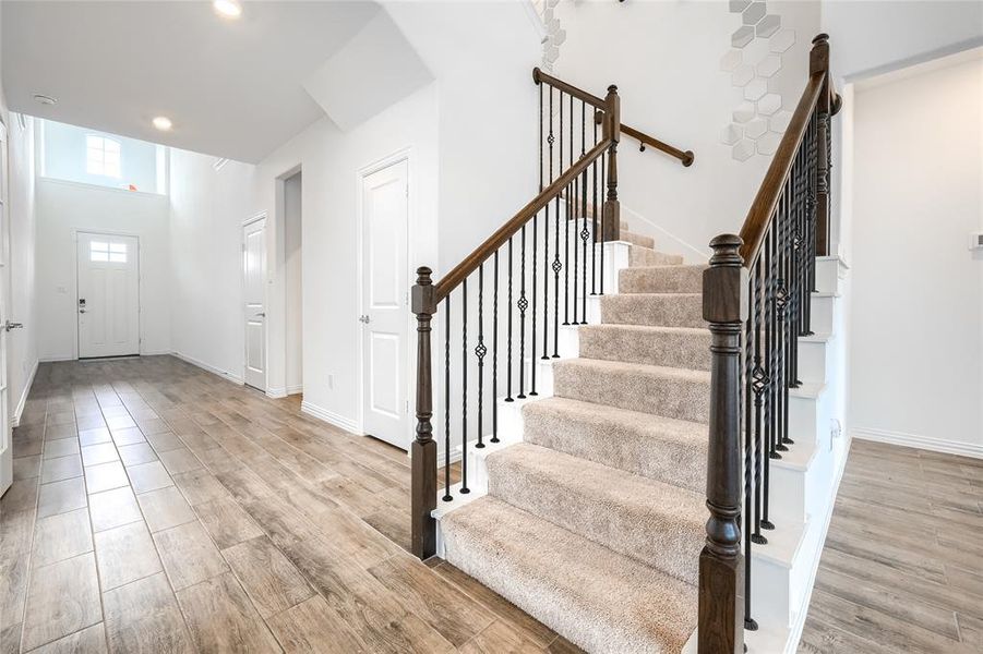 Entryway with light wood-style flooring, recessed lighting, and stairs Entryway with light wood-style flooring, recessed lighting, and stairs