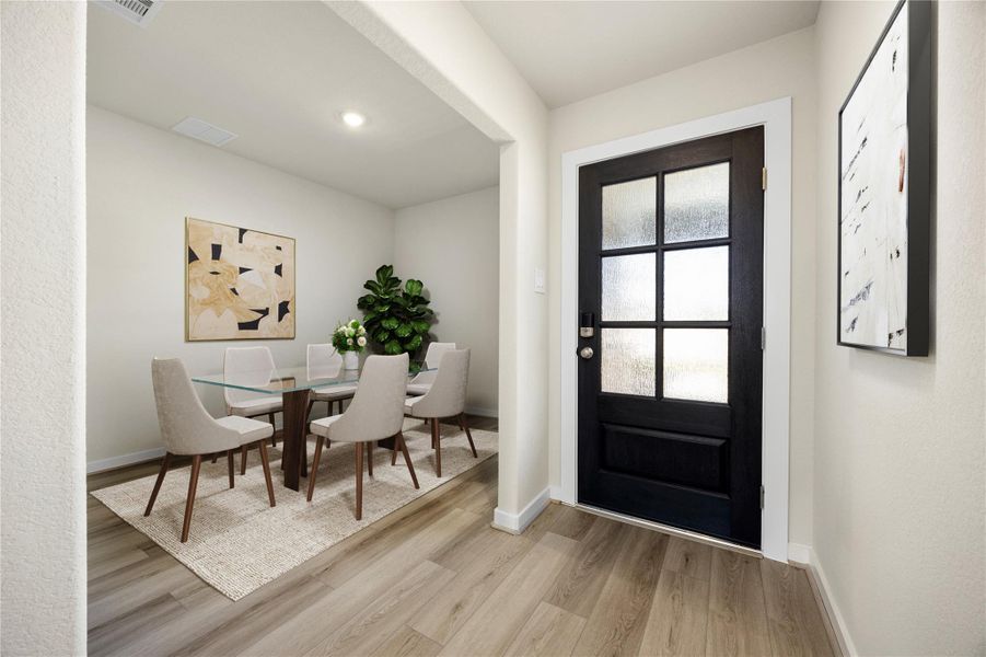 Welcome guests through a stylish entryway that opens to a bright and versatile dining area. With its warm neutral palette, sleek flooring, and inviting ambiance, this space sets the tone for effortless gatherings and memorable meals.