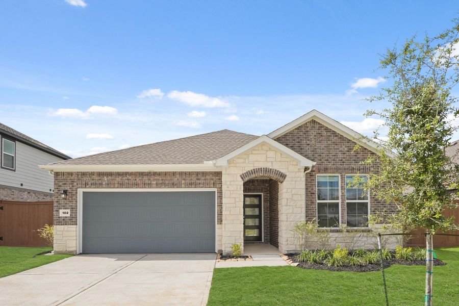 Front exterior of a new home in Woodshore, Clute, TX, highlighting curb appeal (Image 2). Front exterior of a new home in Woodshore, Clute, TX, highlighting curb appeal (Image 2).
