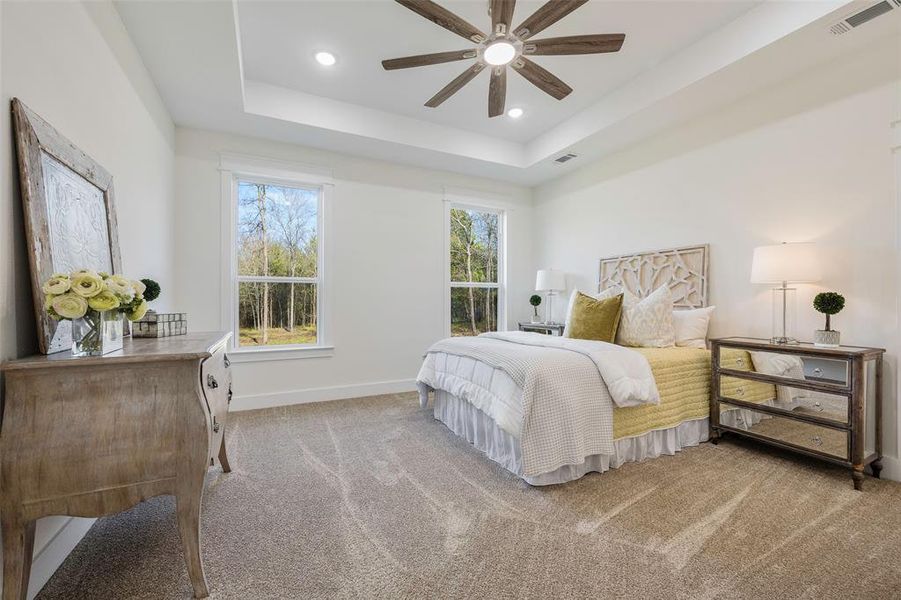 Spacious and sophisticated primary sleeping quarters with en-suite and huge walk-in closet. Plush carpet, dual windows framing picturesque wooded views, and abundant natural light enhance the tranquil ambiance.