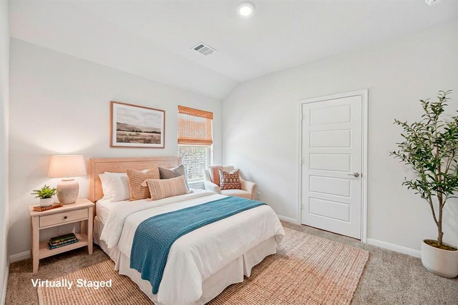 Bedroom with light carpet and vaulted ceiling