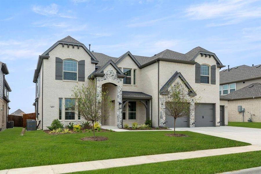 Front exterior of a new home in Woodcreek, Fate, TX, highlighting curb appeal (Image 16). Front exterior of a new home in Woodcreek, Fate, TX, highlighting curb appeal (Image 16).