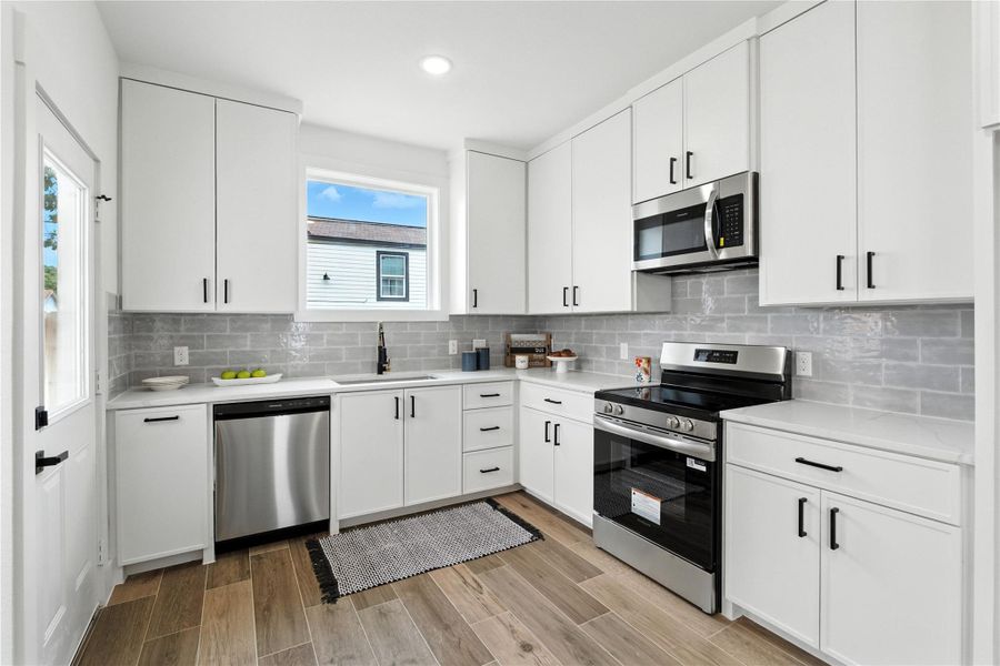 The kitchen is seriously a showstopper—think clean quartz countertops, classic subway tile backsplash, and those eye-catching gold hardware details that pull it all together. Soft-close cabinets keep it sleek and quiet, while the deep undermount sink adds that luxe, modern touch. You've got a built-in trash bin (because no one wants to see a trash can out), a massive walk-in pantry for all the snacks and storage, and appliances already in place—including a microwave, dishwasher, and oven. The kitchen is seriously a showstopper—think clean quartz countertops, classic subway tile backsplash, and those eye-catching gold hardware details that pull it all together. Soft-close cabinets keep it sleek and quiet, while the deep undermount sink adds that luxe, modern touch. You've got a built-in trash bin (because no one wants to see a trash can out), a massive walk-in pantry for all the snacks and storage, and appliances already in place—including a microwave, dishwasher, and oven.