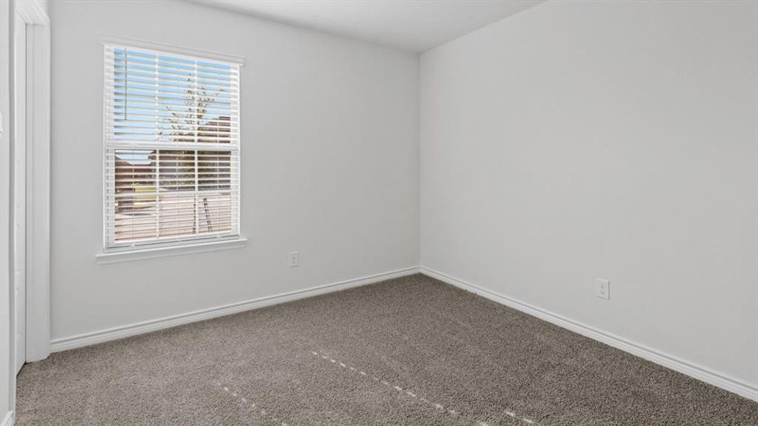 Unfurnished room featuring carpet and baseboards