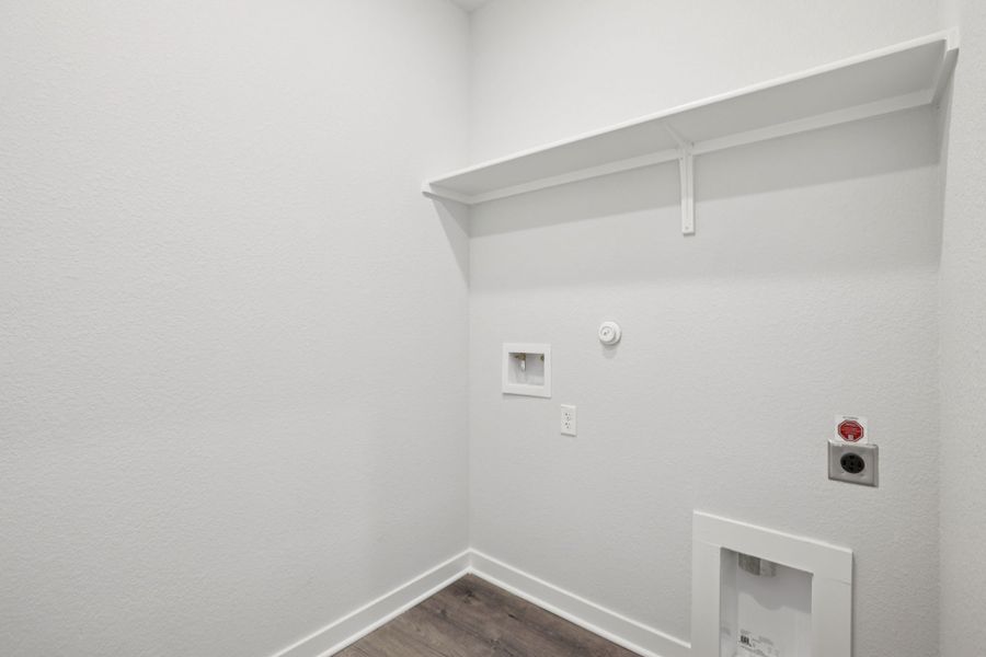 A white wall with a light fixture.