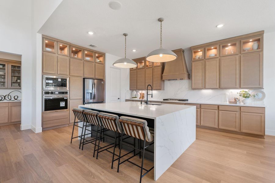 Spacious modern kitchen featuring custom wood cabinetry
